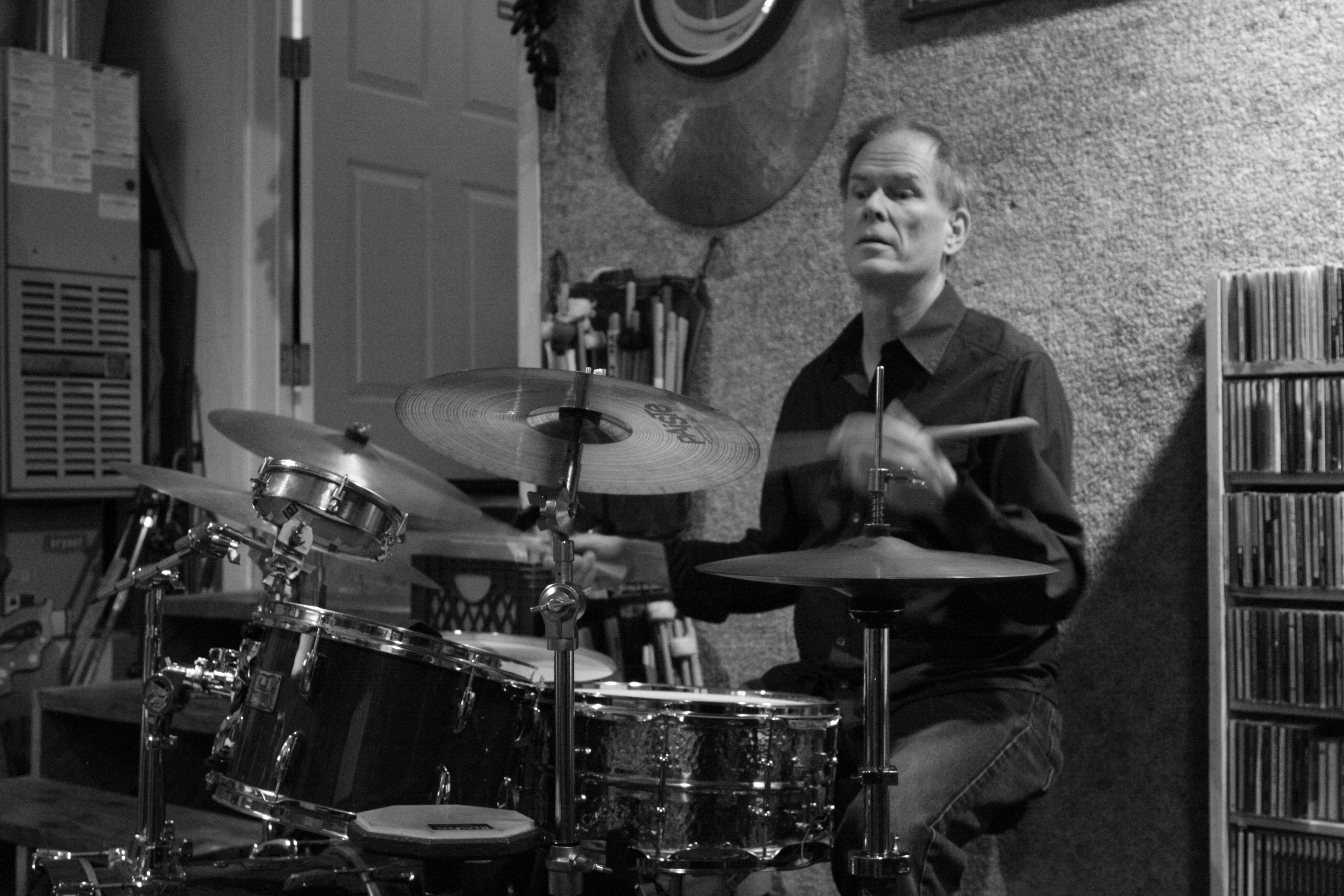 Kendrick Freeman playing drums in black and white