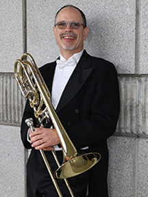 David Ridge holding a trombone