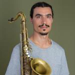 Raffi Garabedian Headshot holding saxophone- cropped