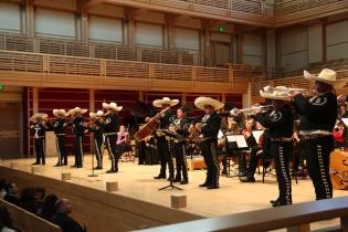 Mariachi band playing on stage with the orchestra