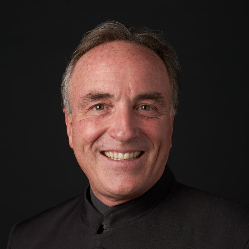 black background portrait of Andy Collinsworth