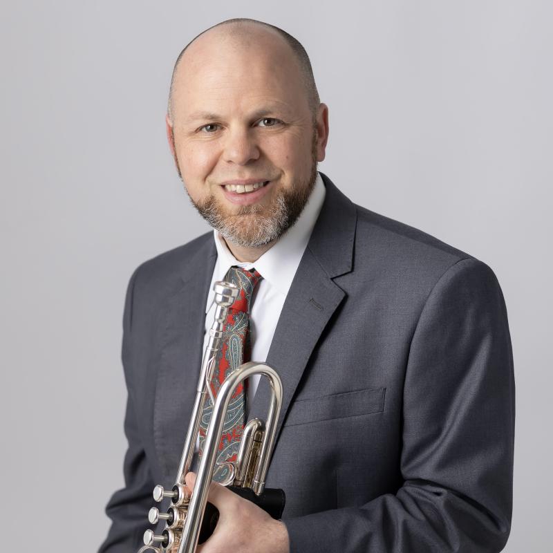 portrait photo of Danial Norris holding his trumpet