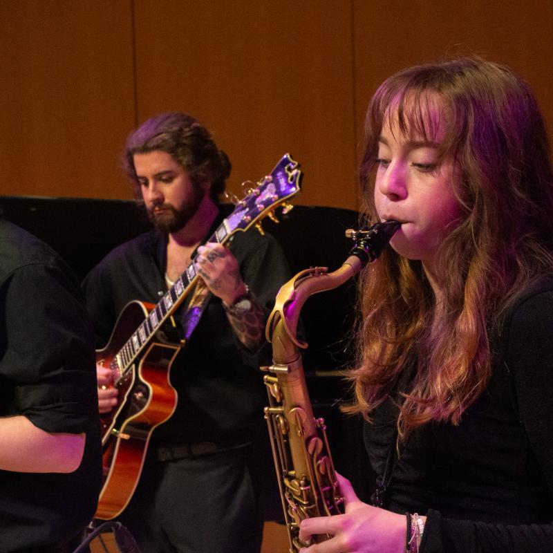 3 SSU music students playing their instruments together