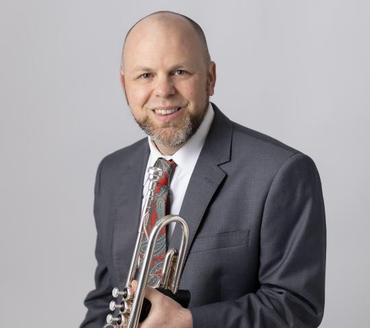 portrait photo of Danial Norris holding his trumpet