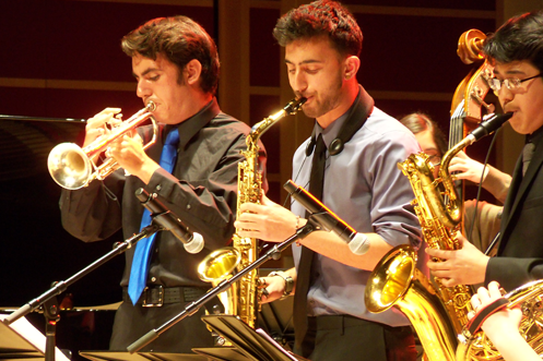 Brass players standing to play