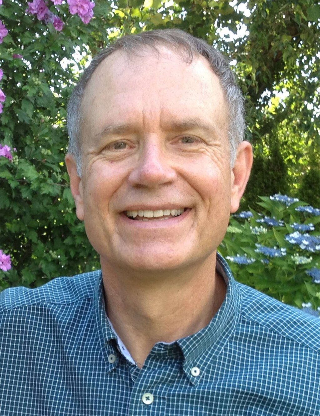 Jeff Langley profile picture in front of greenery and some flowers