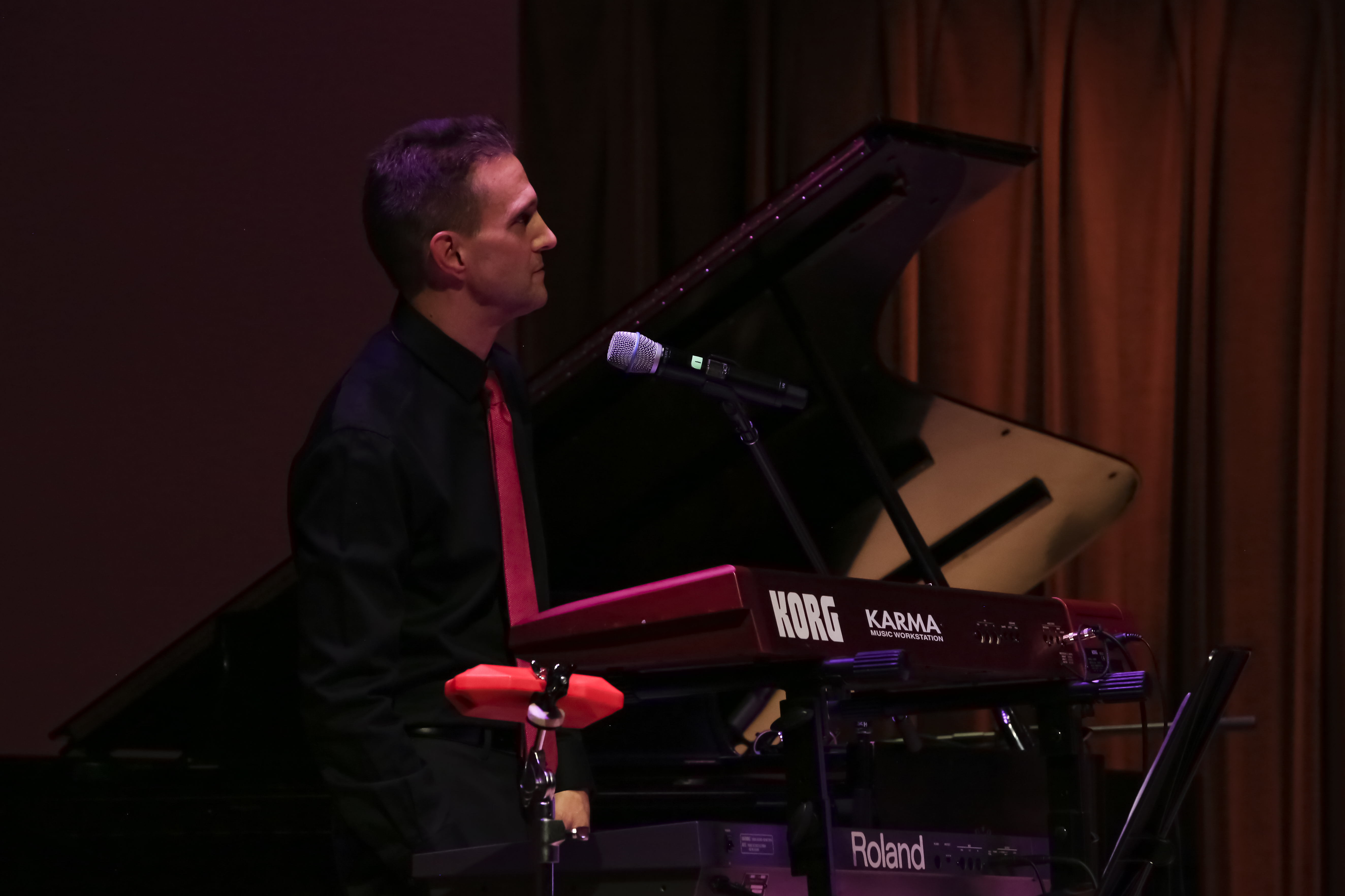 Side profile shot of John Palmer playing keyboards and