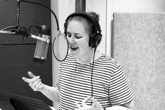 Alison Poteracke singing in a booth