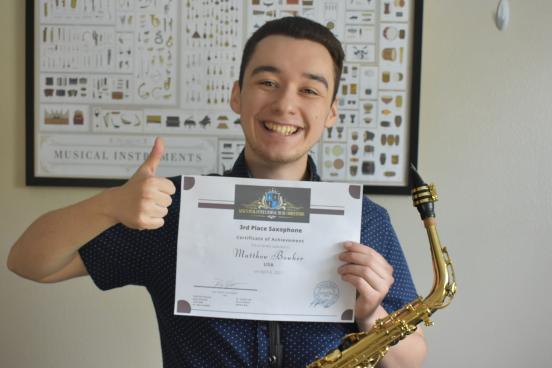 Matthew Bowker holding up certificate 