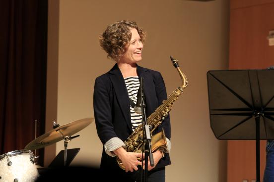 Kasey Knudsen on stage with saxophone
