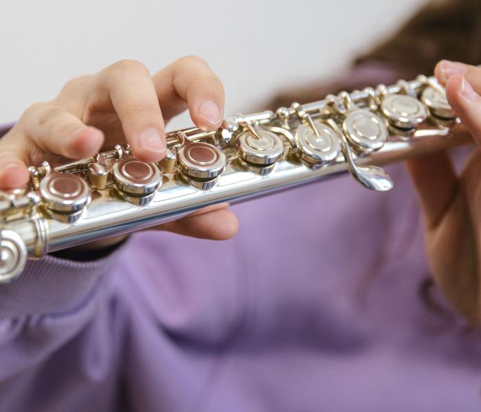 Female hands playing the flute