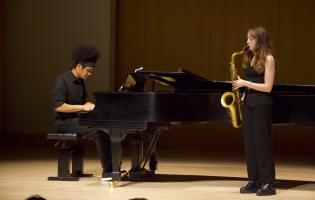 Saxophonist and pianist performing on Schroeder stage