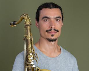 Raffi Garabedian Headshot holding saxophone- cropped