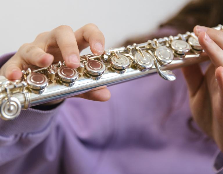 Female hands playing the flute