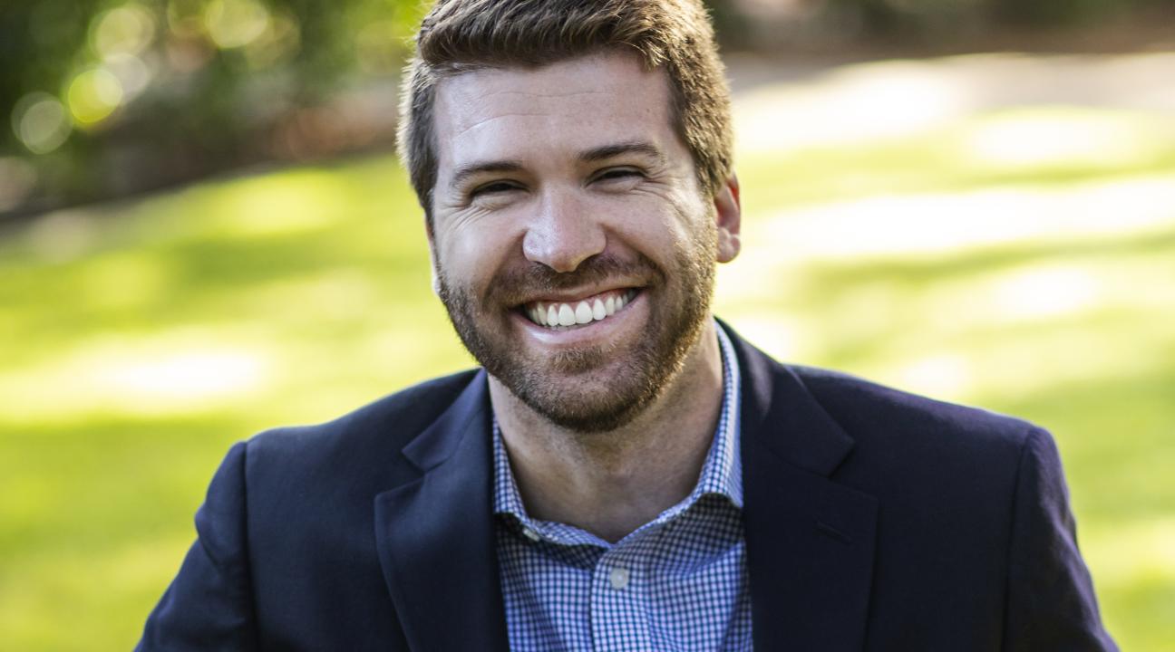 Cody Martin Headshot holding a guitar