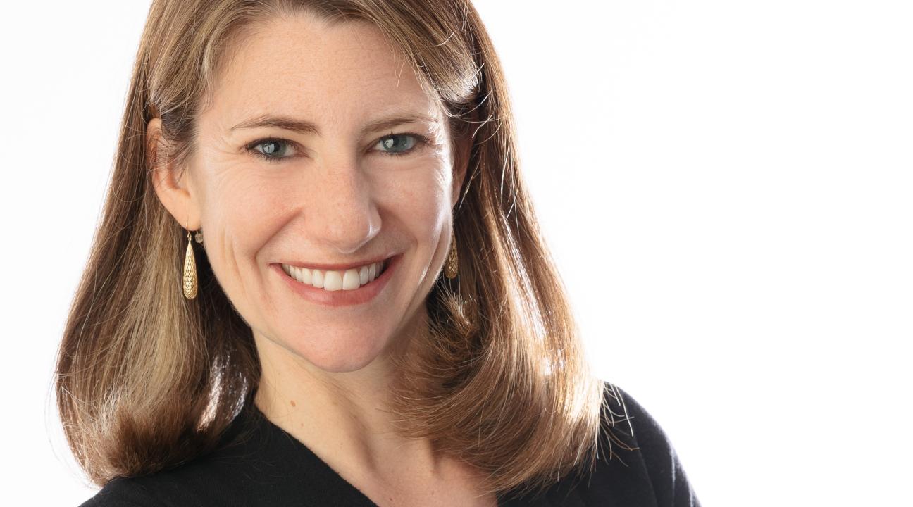 Jenny Bent Headshot with white background and arms folded