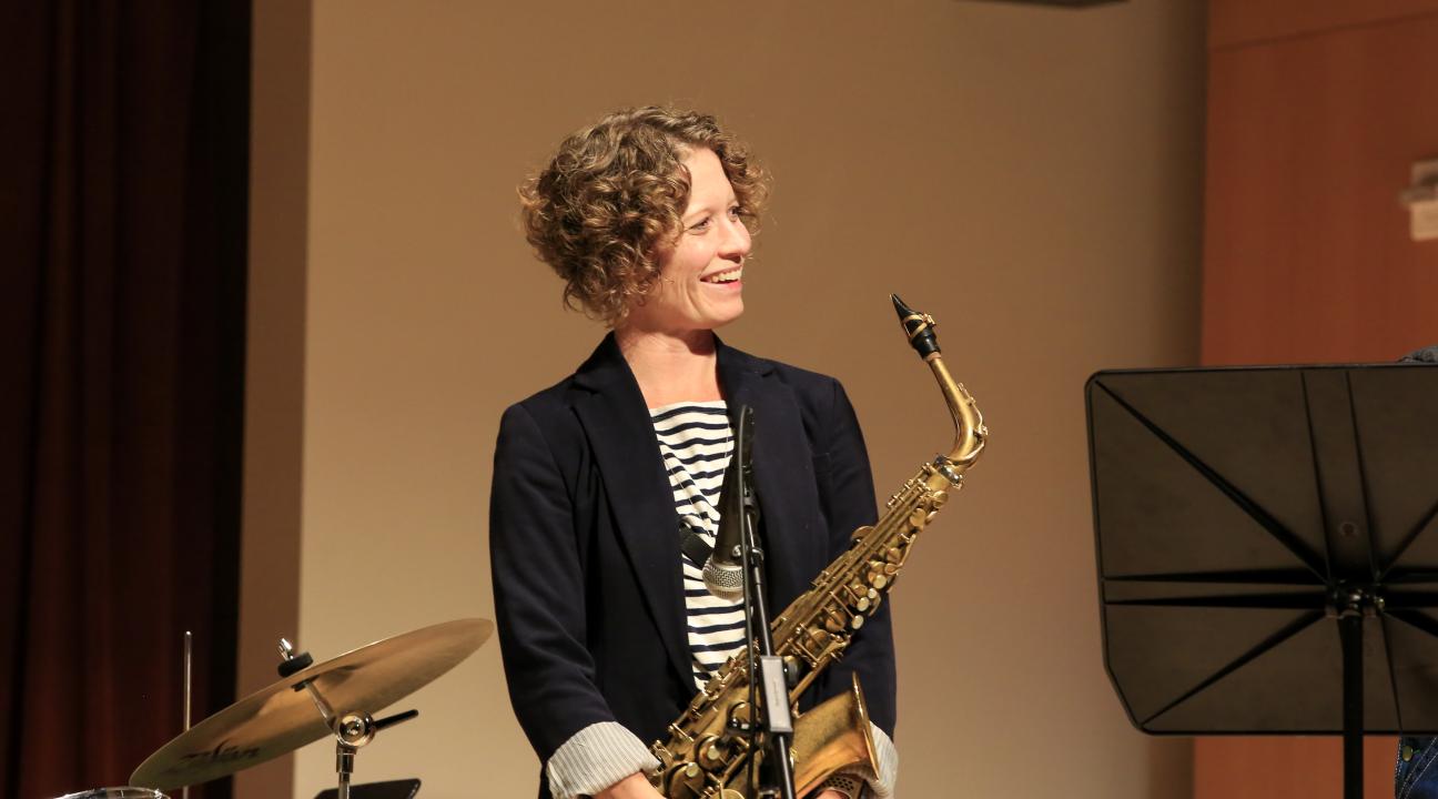 Kasey Knudsen on stage with saxophone