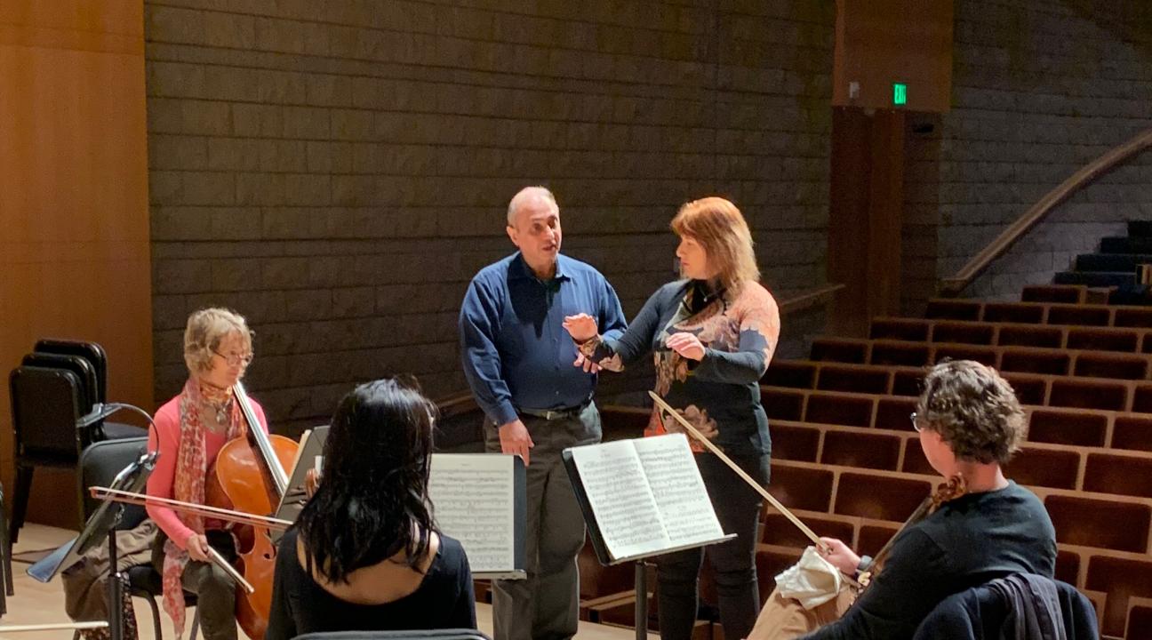 Orchestra instruction on stage with small ensemble