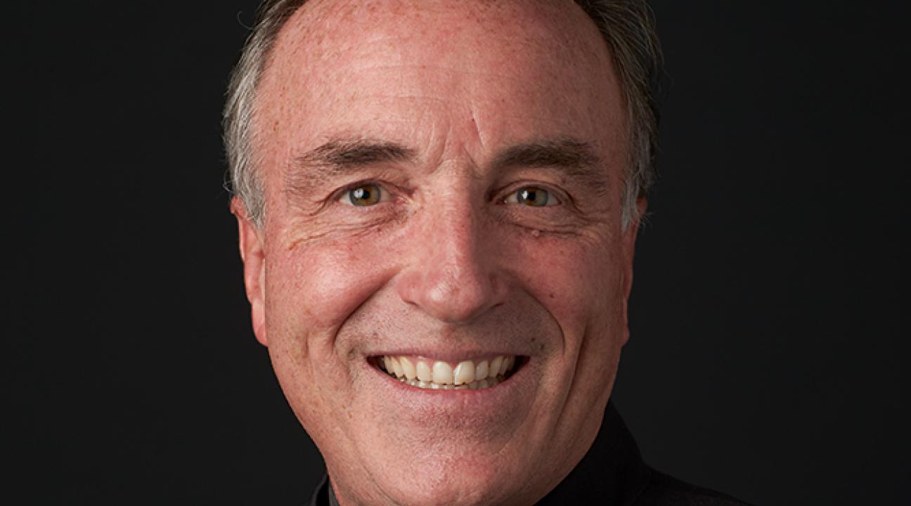 Andy Collinsworth Headshot with black shirt and black background