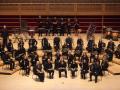 Posed group photo of Wind Ensemble on stage