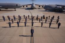 United States Air Force Band of the Golden West standing in front of three airplanes