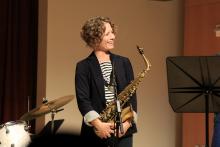 Kasey Knudsen on stage with saxophone