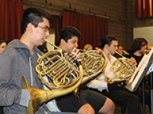 The French horn section of the orchestra rehearses at Sonoma State University