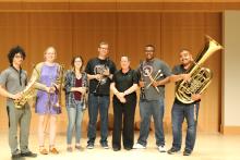 Shown are 6 winds musicians and, Dr. Kim Mieder, who directs the community group.
