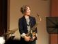 Kasey Knudsen onstage with saxophone