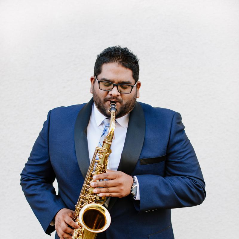 Andrew Harrison headshot playing saxophone