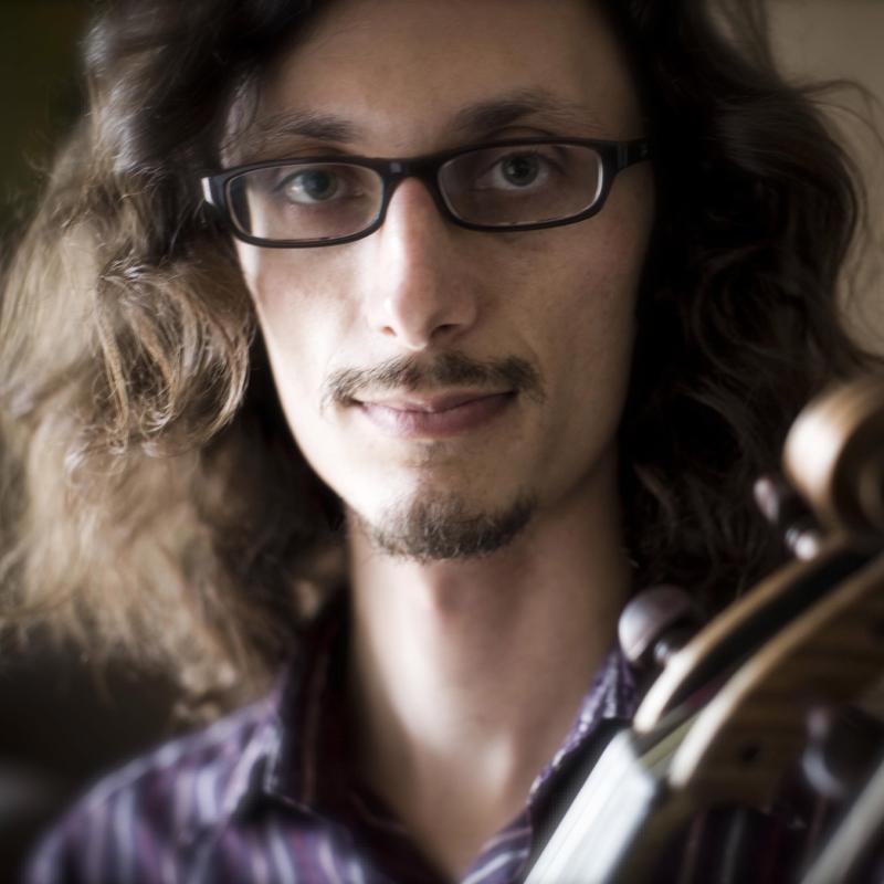 Aaron Westman holding a violin headshot