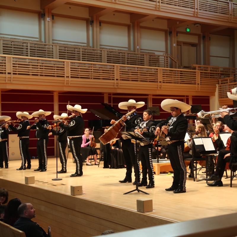Mariachi band playing on stage with the orchestra
