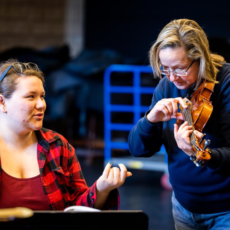 Dr. Kim Mieder teaching violin to a student
