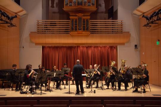 Brass ensemble on stage directed by Dan Norris