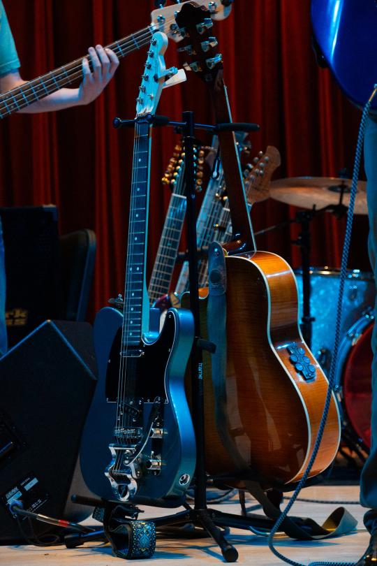 Guitars in stands on stage