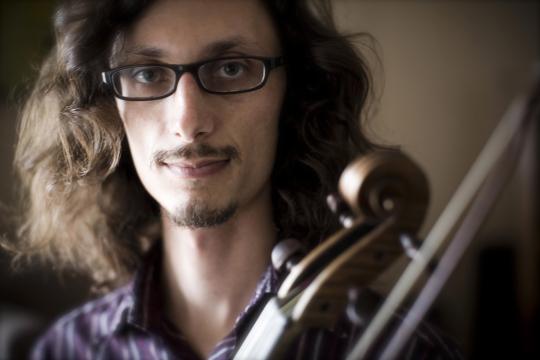 Aaron Westman holding a violin headshot