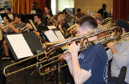 The trombone section of a concert band practice for their Instrumental Repertoire