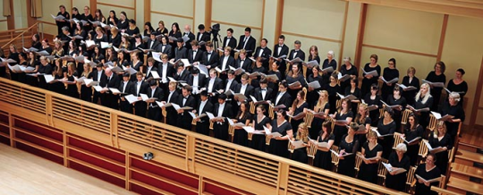 Choir standing and singing in choir loft
