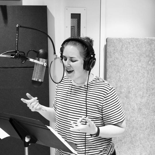 Alison Poteracke singing in a booth