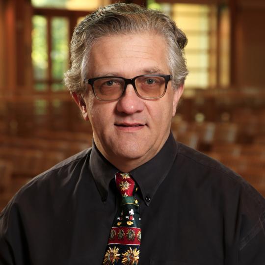 Brian Wilson cropped headshot in Weill Hall with Mickey Mouse tie