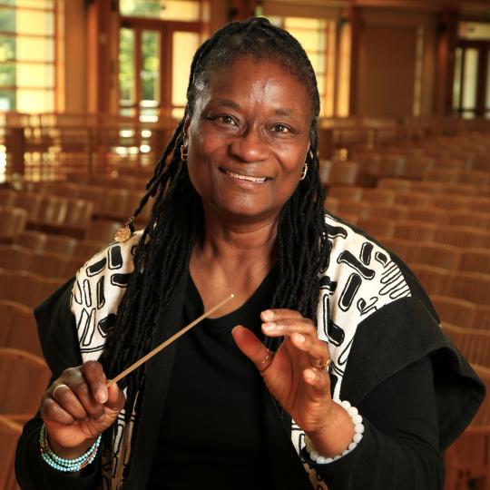 Lynne Morrow Headshot holding baton