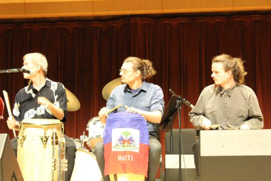 Three drummers playing Haitian drums play in the SSU Jazz Ensemble year end performance.