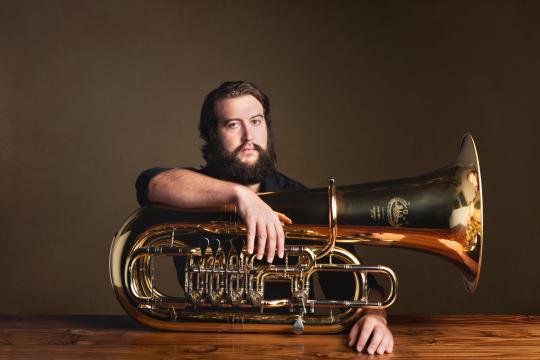 Jonathan Seiberlich with Tuba resting on wooden table