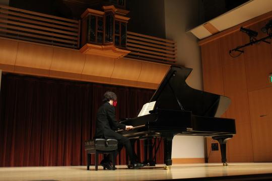 Hikaru Hallberg playing piano on Schroeder stage