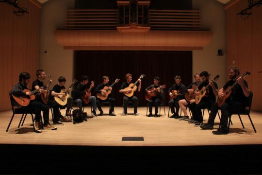 Guitar ensemble playing on Schroeder Hall stage