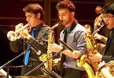 This is a picture of some saxophone players and a trumpet player