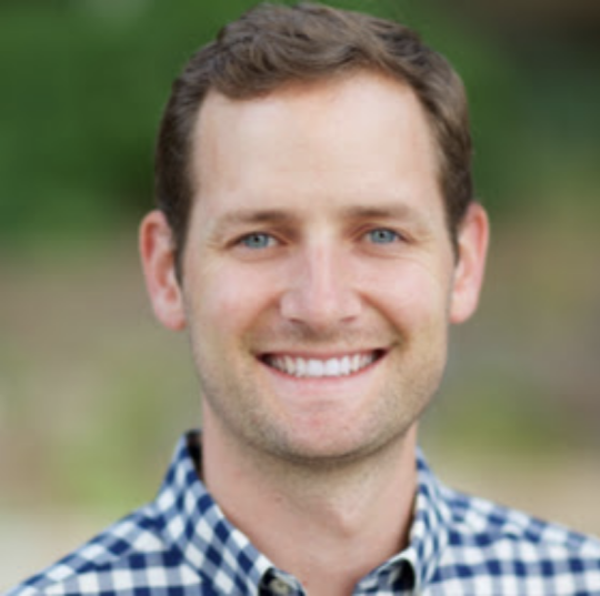 Josh Little headshot with blurry background