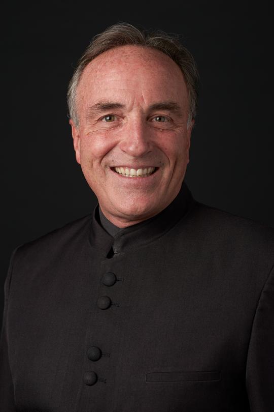 Andy Collinsworth Headshot with black shirt and black background