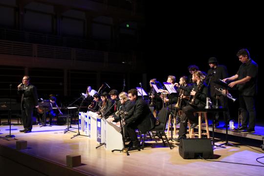 Jazz Orchestra on stage with director Doug Leibinger on the mic