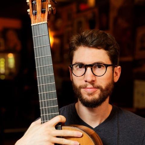 Thomas Viloteau headshot with guitar